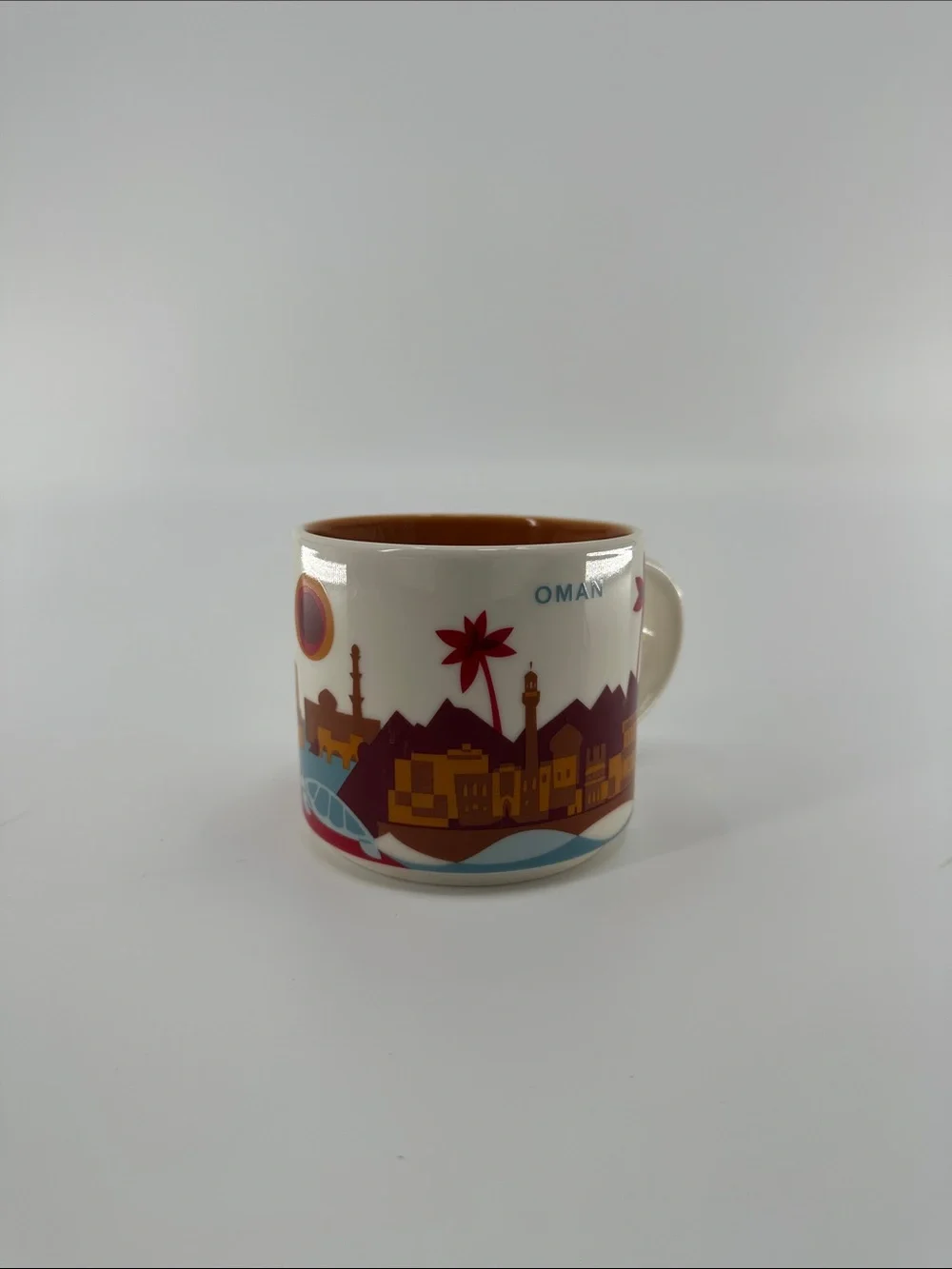 Starbucks Oman Cream Cityscape Mug with Orange Interior and Red Accents